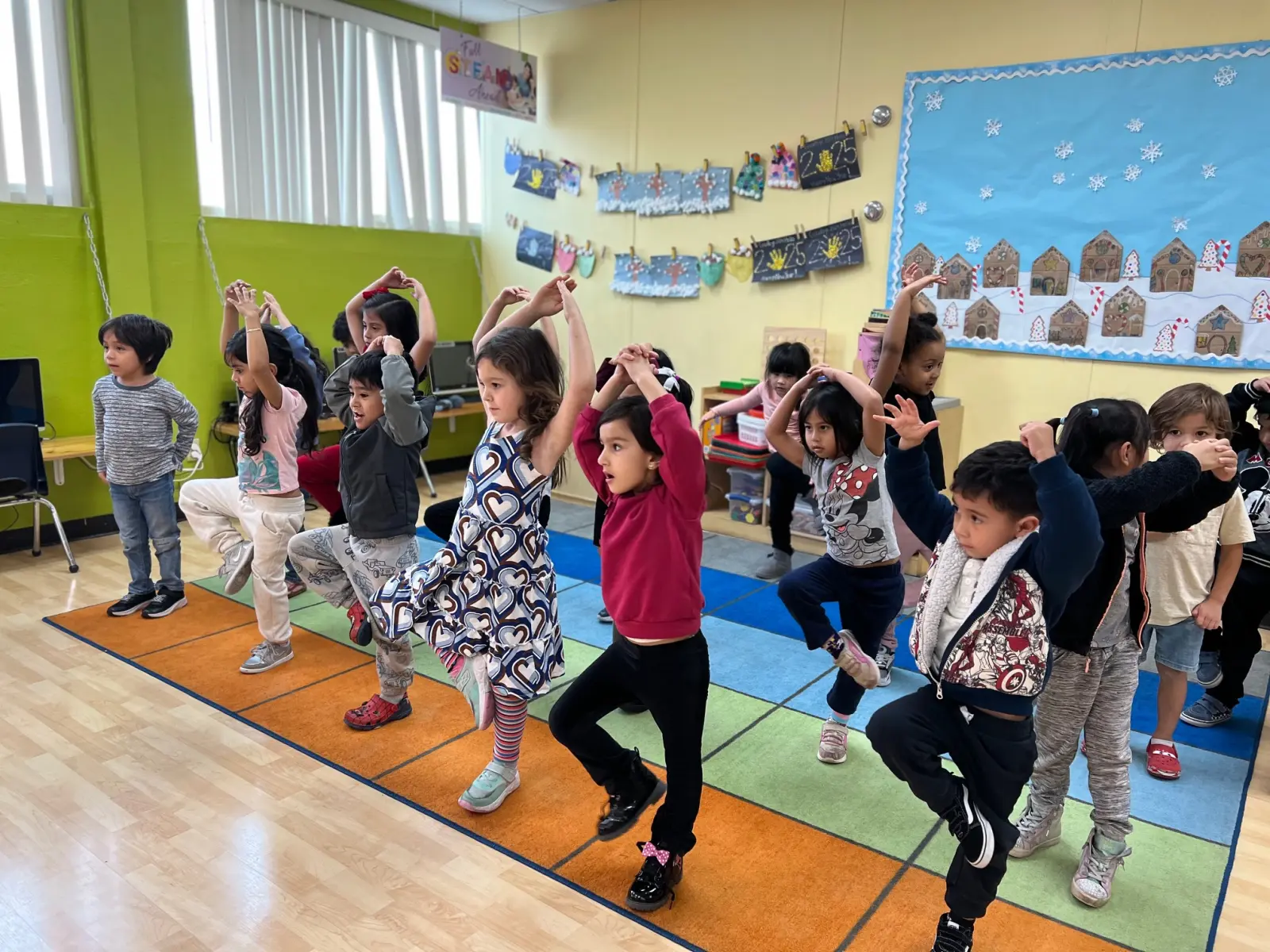 Teacher reading a story to toddlers in Fullerton, demonstrating the conversational back-and-forth that supports executive function development