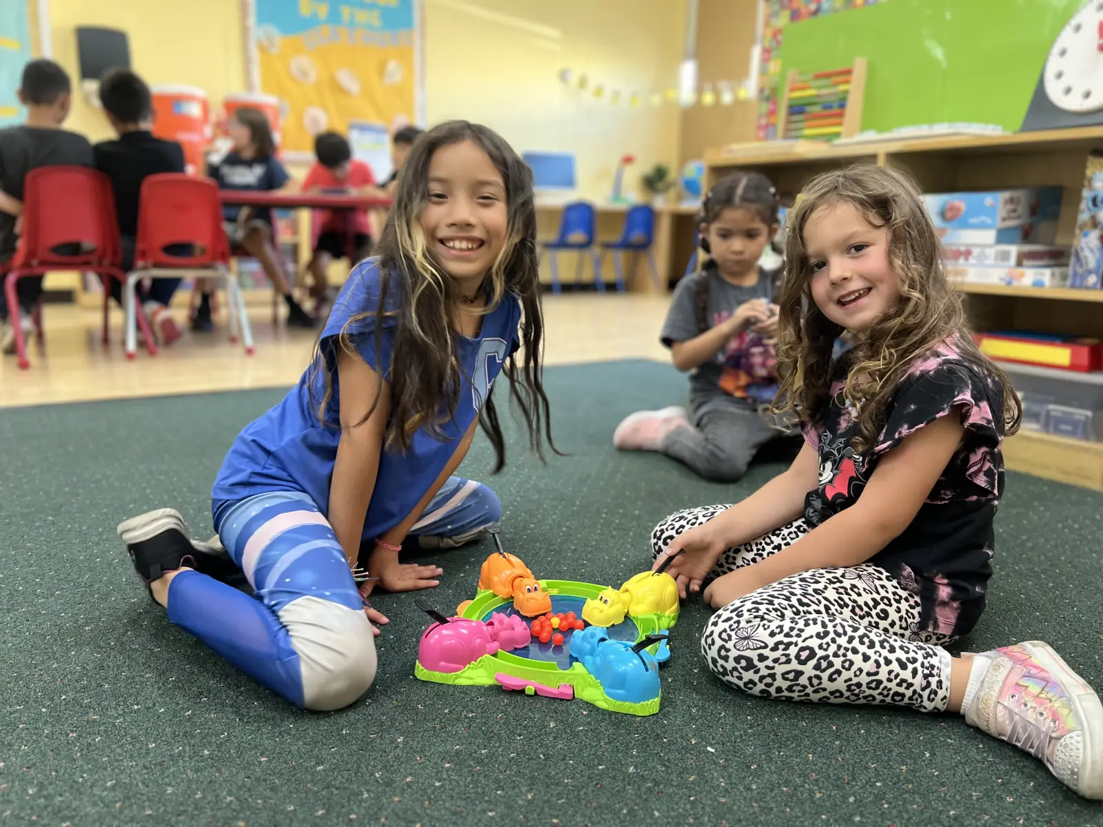 Preschool classroom in Fullerton showing children working independently on hands-on materials at low tables, an environment that supports executive function development