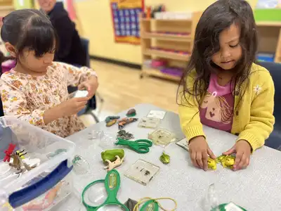 Experienced and caring teachers nurturing toddlers in a safe, secure classroom environment at Kids Adventure Learning Center