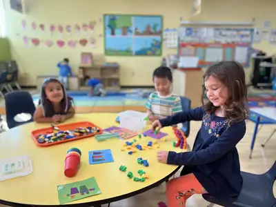 Children exploring science and engineering through hands-on STEAM learning activities at Kids Adventure Learning Center