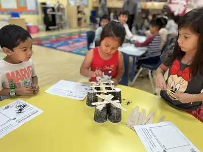 Small Pre-K classroom with engaged children and teacher fostering strong community bonds and individualized learning at Kids Adventure Learning Center