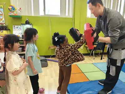 Children practicing Tae Kwon Do and soccer in Kids Adventure Learning Center's sports enrichment building teamwork, discipline, and leadership