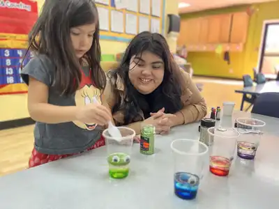 School-age children receiving dedicated homework supervision and enjoying healthy afternoon snacks in a structured after-school environment at Kids Adventure Learning Center