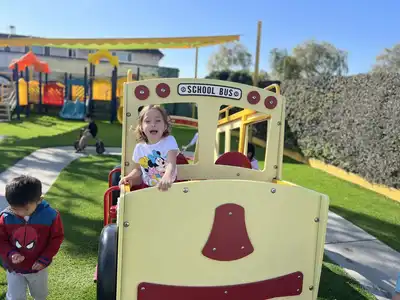 Safe outdoor playground with age-appropriate play structures, equipment, and secured play centers at Kids Adventure Learning Center